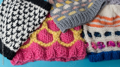 a pile of colourful hand knitting - background with space for text