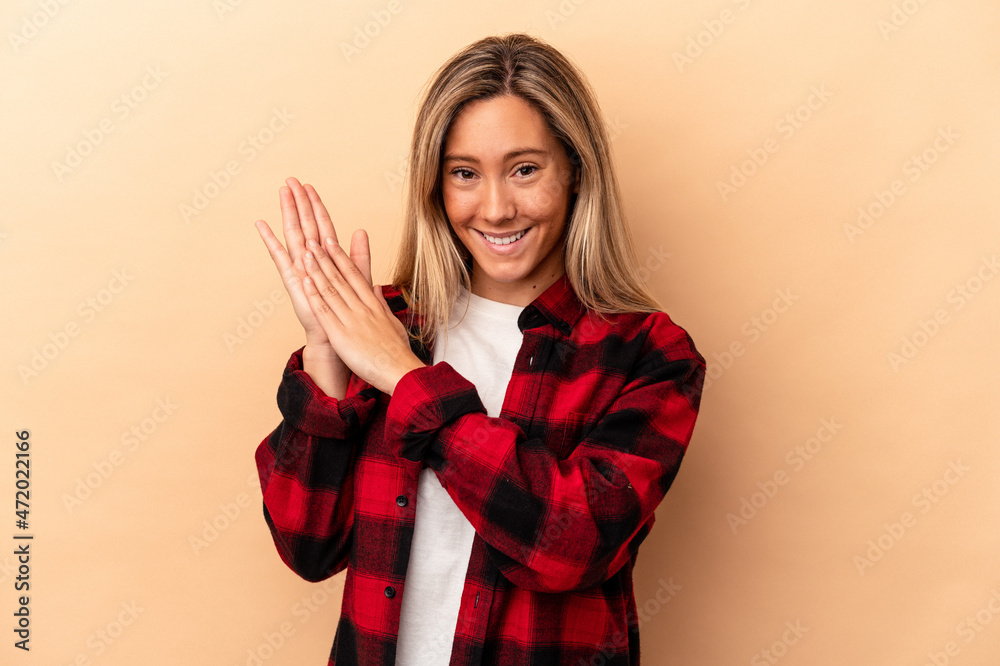 Young caucasian woman isolated on beige background feeling energetic and comfortable, rubbing hands confident. Young caucasian woman isolated on beige background feeling energetic and comfortable, rubbing hands confident.