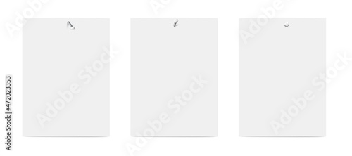 Set of rectangular vertical blank sheets on wall, attached with metal nails
