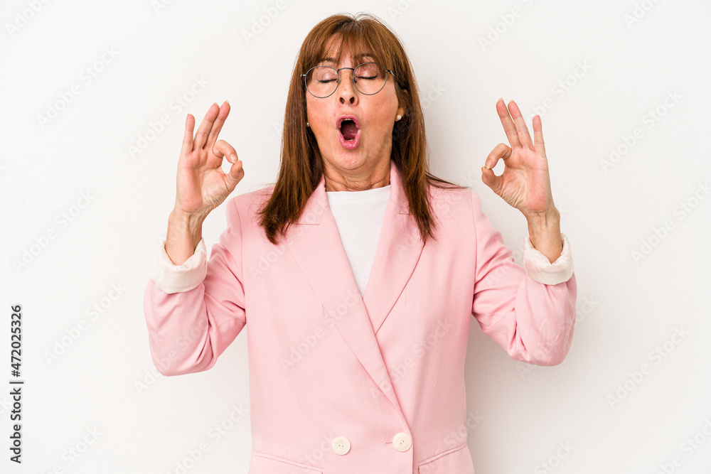 Middle age caucasian woman isolated on white background relaxes after hard working day, she is performing yoga.