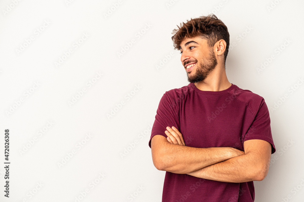Fototapeta premium Young mixed race man isolated on grey background smiling confident with crossed arms.