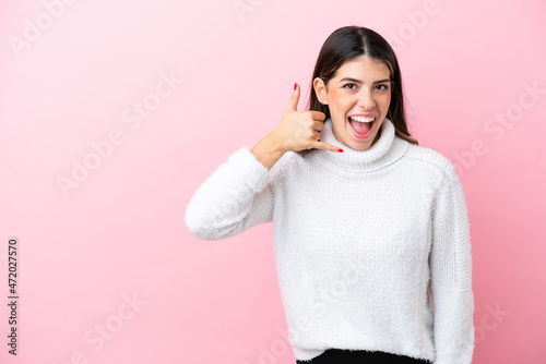 Young Italian woman isolated on pink background making phone gesture. Call me back sign