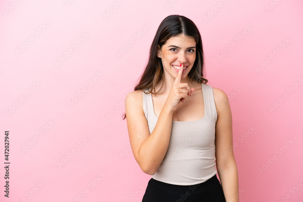 Young Italian woman isolated on pink background showing a sign of silence gesture putting finger in mouth Young Italian woman isolated on pink background showing a sign of silence gesture putting finger in mouth