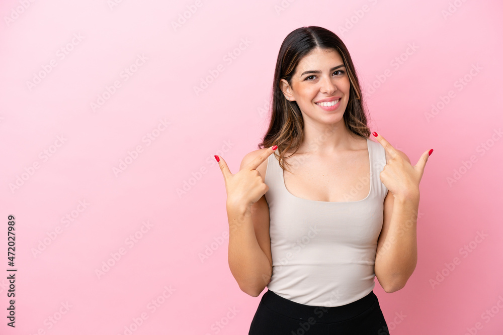 Young Italian woman isolated on pink background giving a thumbs up gesture Young Italian woman isolated on pink background giving a thumbs up gesture