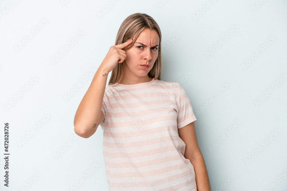 Young caucasian woman isolated on blue background pointing temple with finger, thinking, focused on a task. Young caucasian woman isolated on blue background pointing temple with finger, thinking, focused on a task.