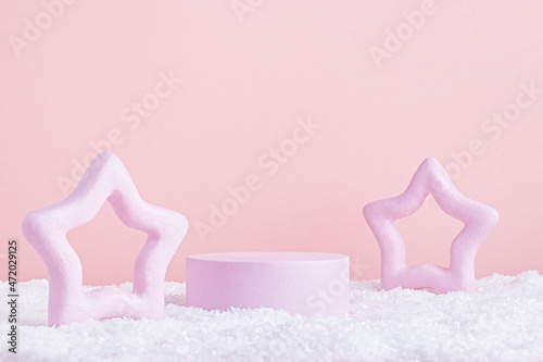 Christmas or winter pink podium for product display with pink star shaped decor on pink photo