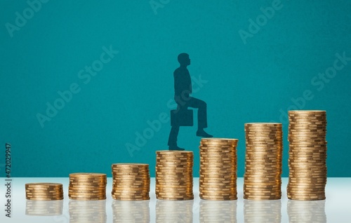 Economic growth stimulus. Concept with coins, person rising on coins