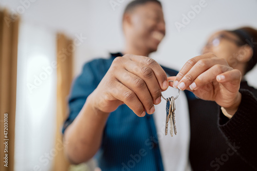 Close-up of hands holding keys to an apartment, married couple buying, renting a new apartment, the beginning of their journey together, real estate industry, investment