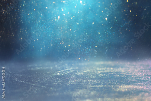 background of abstract glitter lights. gold, blue and silver. de focused