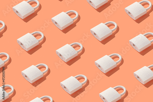 Pattern from padlock on trendy coral background. Minimal concept of protection and security.
