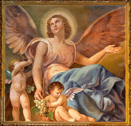 FORLÍ, ITALY - NOVEMBER 11, 2021: The fresco of angel with the grape in the Cattedrala di Santa Croce  by Giovanni Secchi (1876 - 1950).; photo