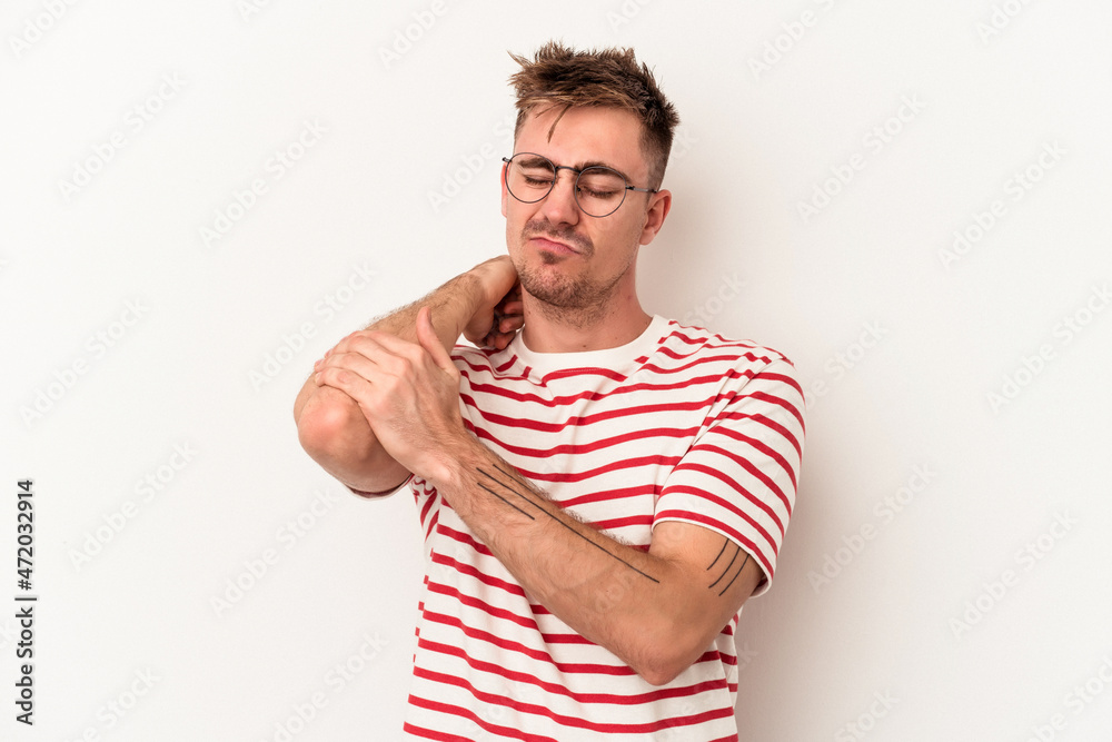 Young caucasian man isolated on white background massaging elbow, suffering after a bad movement. Young caucasian man isolated on white background massaging elbow, suffering after a bad movement.