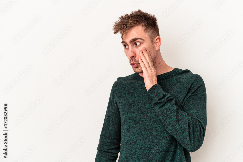 Young caucasian man isolated on white background being shocked because of something she has seen. Young caucasian man isolated on white background being shocked because of something she has seen.