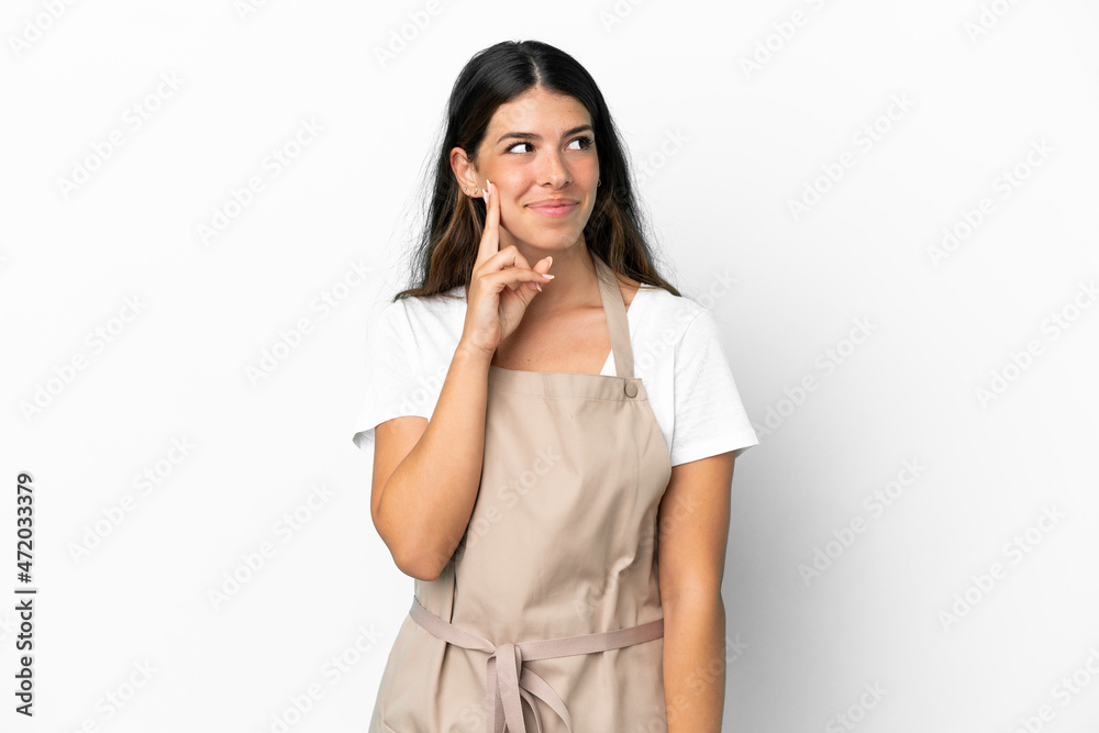 Restaurant waiter over isolated white background thinking an idea while looking up Restaurant waiter over isolated white background thinking an idea while looking up