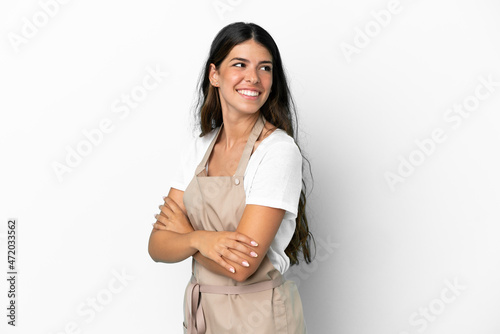 Restaurant waiter over isolated white background with arms crossed and happy