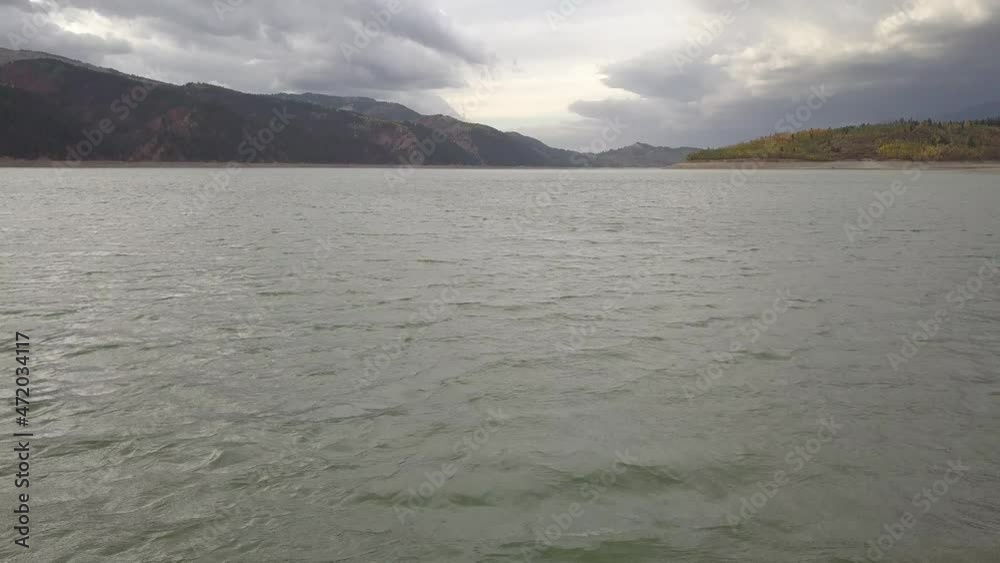 tilt up from big mountain lake on overcast day tilt up from big mountain lake on overcast day