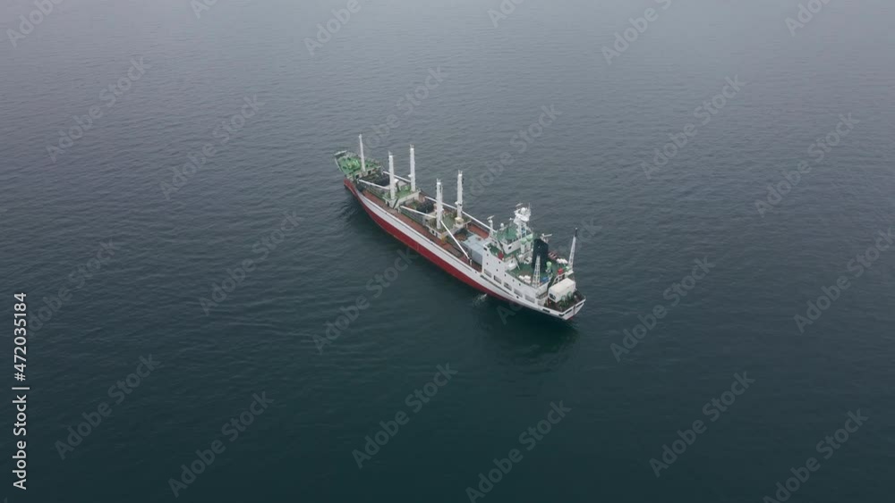 Aerial shot. Top view of a dry cargo ship in the sea Aerial shot. Top view of a dry cargo ship in the sea