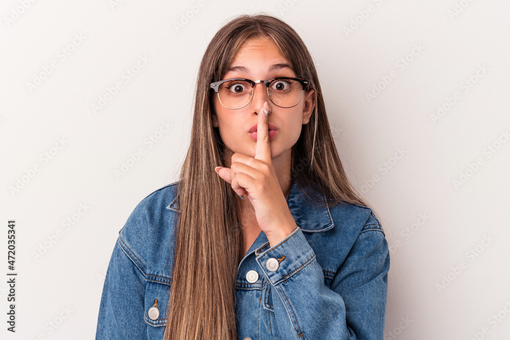 Young caucasian woman isolated on white background keeping a secret or asking for silence. Young caucasian woman isolated on white background keeping a secret or asking for silence.