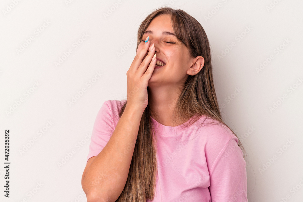 Young caucasian woman isolated on white background laughing happy, carefree, natural emotion.