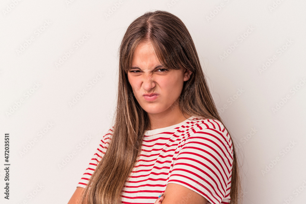 Young caucasian woman isolated on white background frowning face in displeasure, keeps arms folded. Young caucasian woman isolated on white background frowning face in displeasure, keeps arms folded.