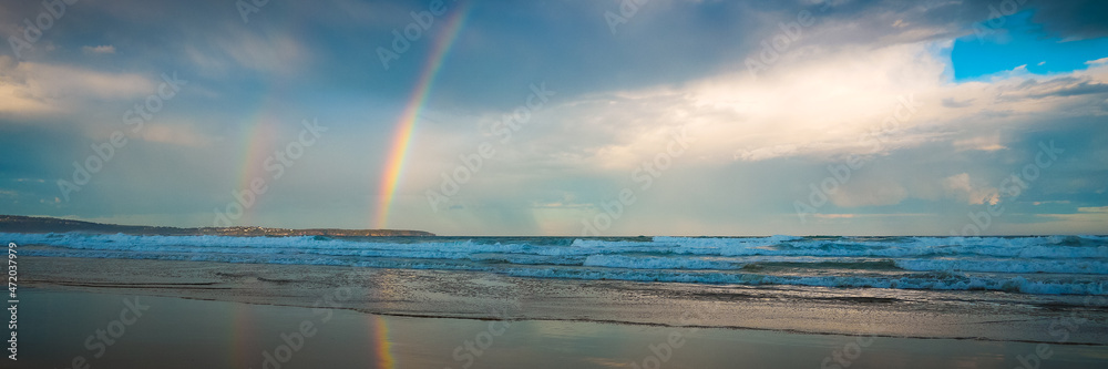 Rainbow over the sea and beach in Pambula - Panorama