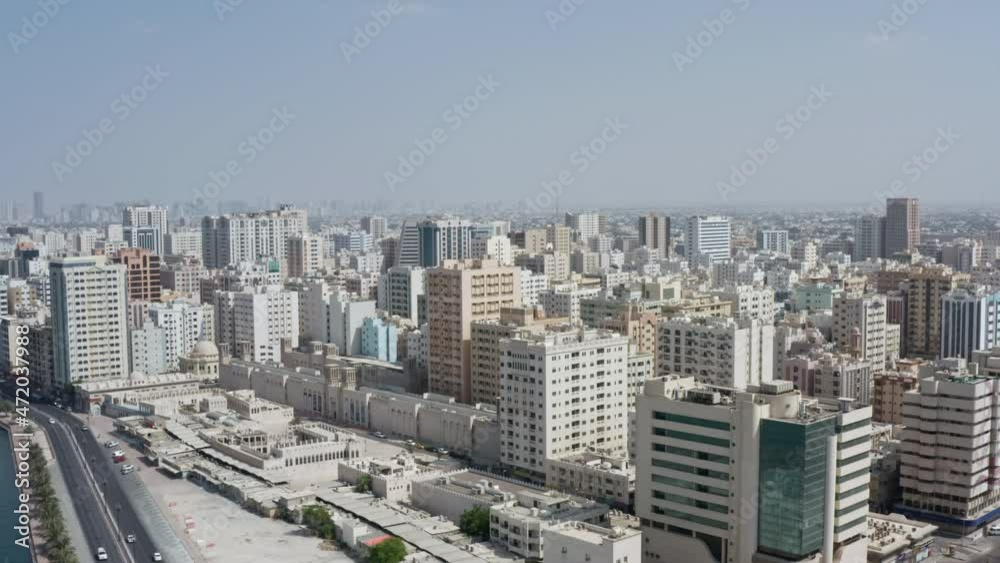 Aerial view of Sharjah UAE cityscape. Modern architecture of the city in the desert, downtown with skyline business centers roads and streets. Aerial view of Sharjah UAE cityscape. Modern architecture of the city in the desert, downtown with skyline business centers roads and streets.