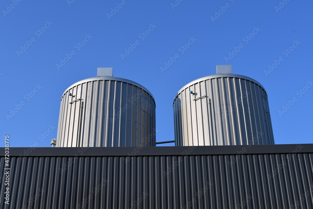 Big overground storage tanks for bitumen. Bitumen is a residual material used for asphalt production.