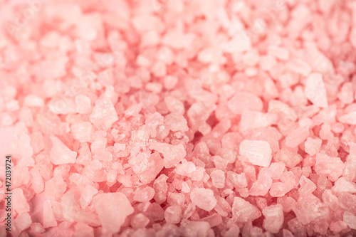 texture of pink aromatic bath salt. selective focus. background for spa treatments.