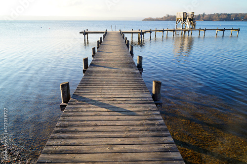 a long wooden pier in Herrsching on Lake Ammersee in Bavaria on a clear December day (Germany) 