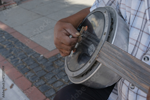 Edirne, Turkey - 09|19|2021 : a man playing in the street on a traditional Turkish instrument with 12 strings photo