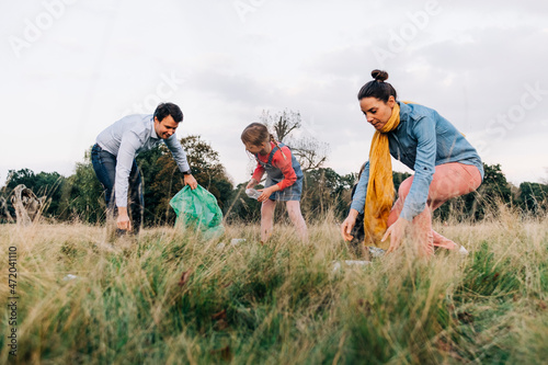 Family doing cleanup in public park