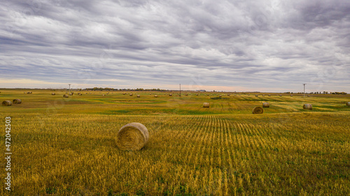 A bale of hay sitting in the middle of a field in the great plains of North Dakota.