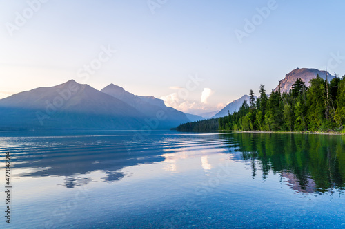 Sunset over Lake McDonald in Glacier National Park in Montana - colorful pebbles visible through the clear water