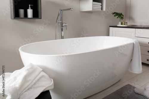 Stylish bathroom interior with modern white tub