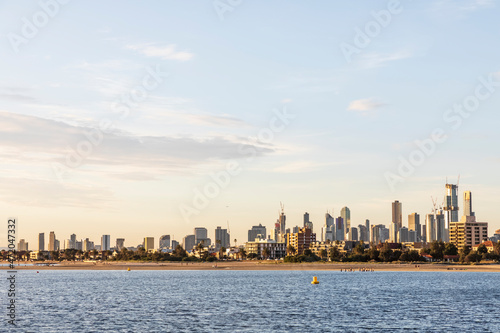 Australia, Victoria, Melbourne, Port Philip Bay at summer dusk with city skyline in background photo