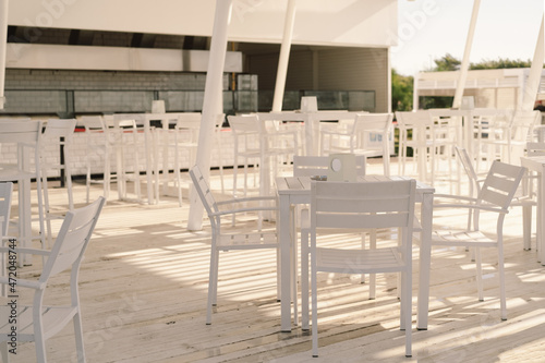 White table and chairs in cafe outdoors. Street cozy restaurant © Анастасія Стягайло