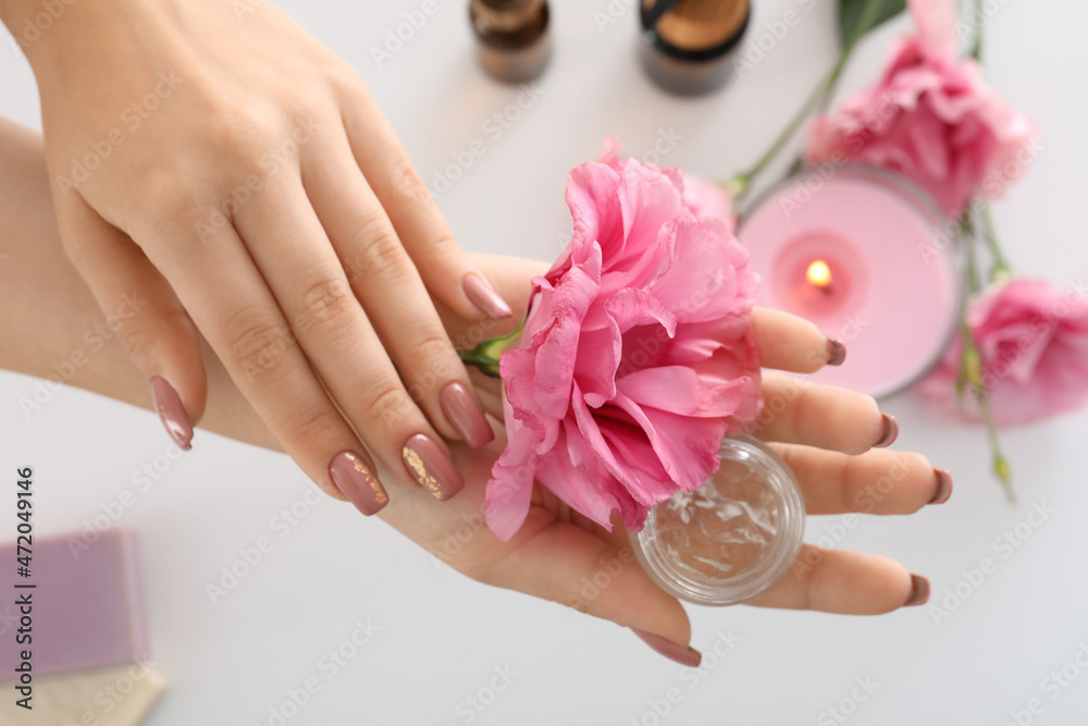 Fototapeta premium Concept of hand care with cosmetics on white background