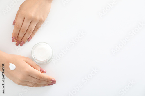 Concept of hand care with cosmetics on white background