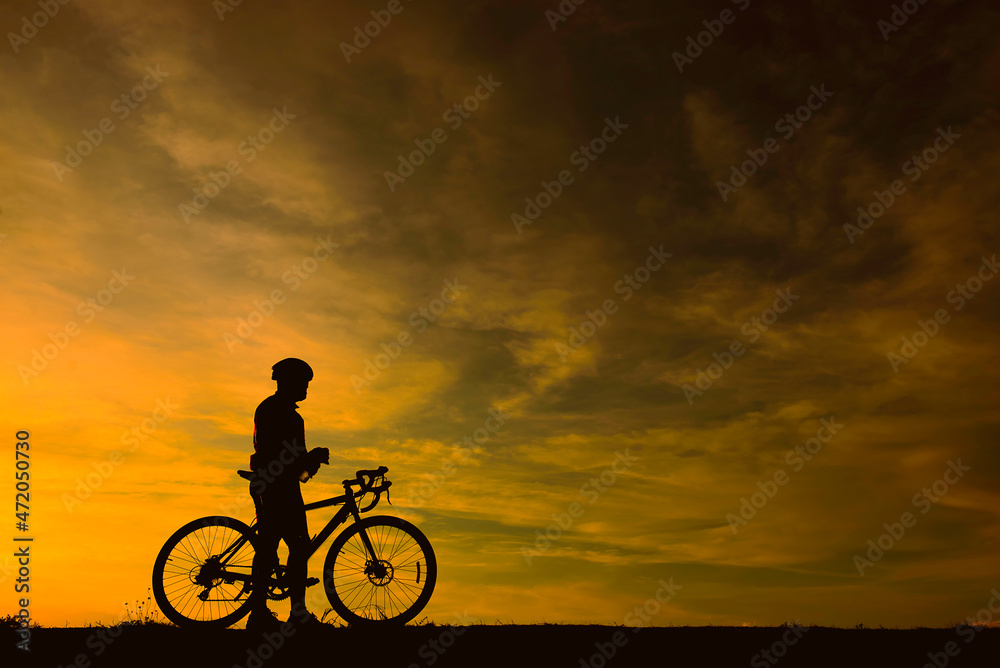 Silhouette of handsome man riding bicycle on sunset,sport man concept,Fill flare effect Silhouette of handsome man riding bicycle on sunset,sport man concept,Fill flare effect