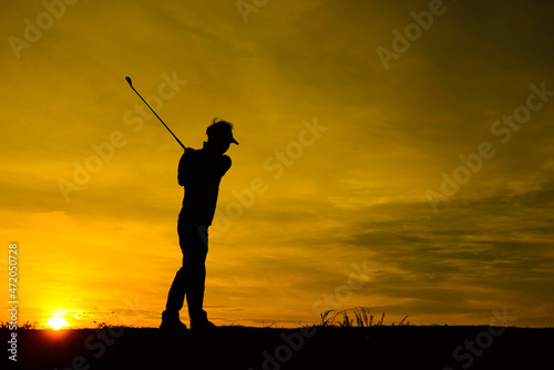 silhouette asian golfer playing golf during beautiful sunset