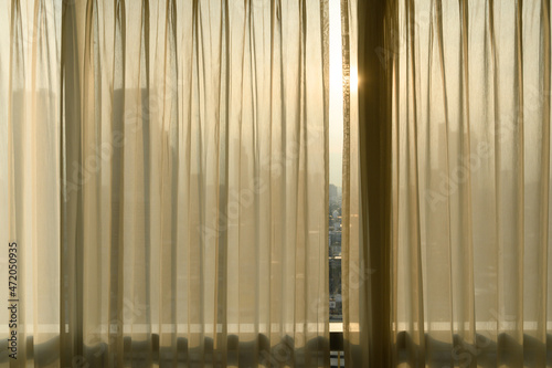Sheer curtains with cityscape onbackground. transparent curtain in cozy room home  interior design concept.