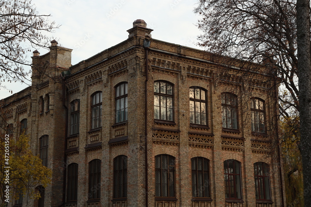 Fototapeta premium Vintage brick building and trees