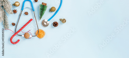 Christmas medical composition on a blue background with Christmas toys and a stethoscope. Place for text