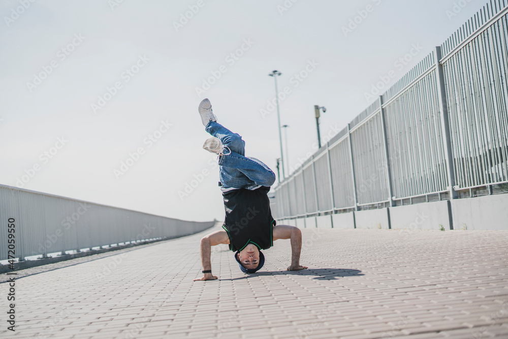 young male person doing headstand outdoors young male person doing headstand outdoors