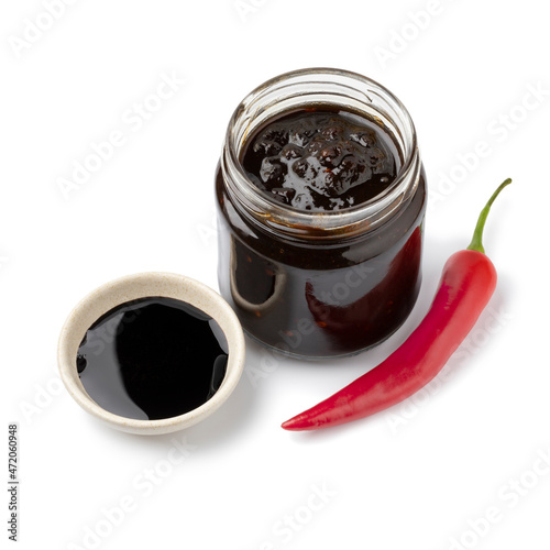 Glass jar with a variation of sambal, chili sauce, with soy sauce isolated on white background photo