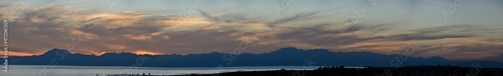 Panoramic sunset photo against the background of mountains and evening sky