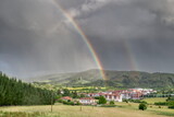 Double rainbow with a stormy sky over the town of Larrabetzu.