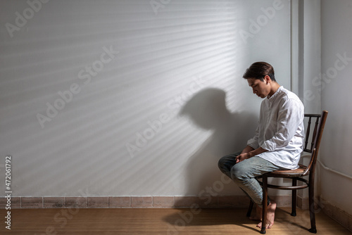 Male depression. Upset Asian young man got problem sitting alone at home, a lot of thoughts, break up with a lover or financial difficulties and debt Overthinking Unhappy unsatisfied and trouble idea