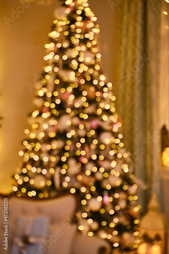Beautiful Christmas lights on blurry fir tree.