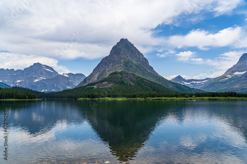 Swiftcurrent Lake at Many Glacier in Glacier National Park in Montana on a cloudy summer day photo